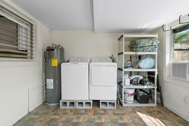 clothes washing area with washing machine and dryer and water heater