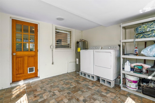 clothes washing area with water heater and independent washer and dryer