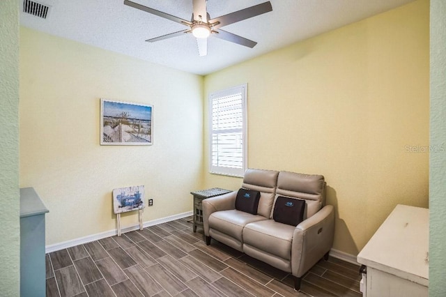 living area with ceiling fan