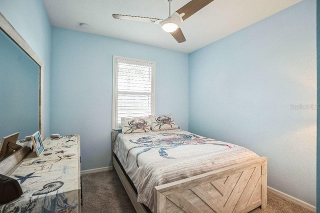 bedroom featuring ceiling fan and dark colored carpet