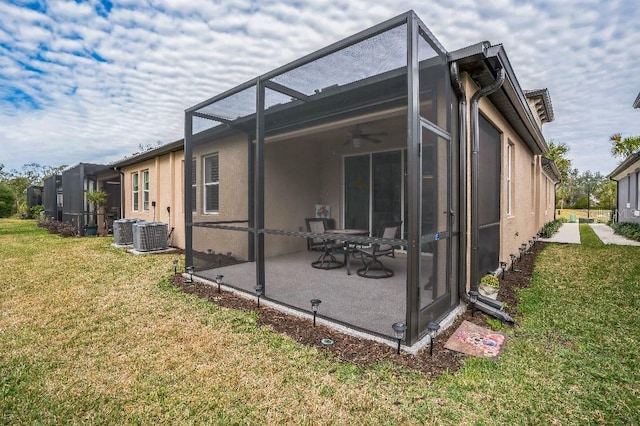 view of home's exterior with a lanai, a lawn, ceiling fan, cooling unit, and a patio