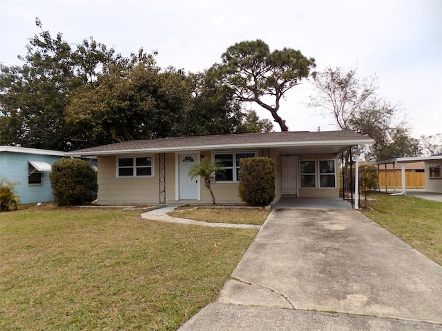 view of front of home with a front yard and a carport