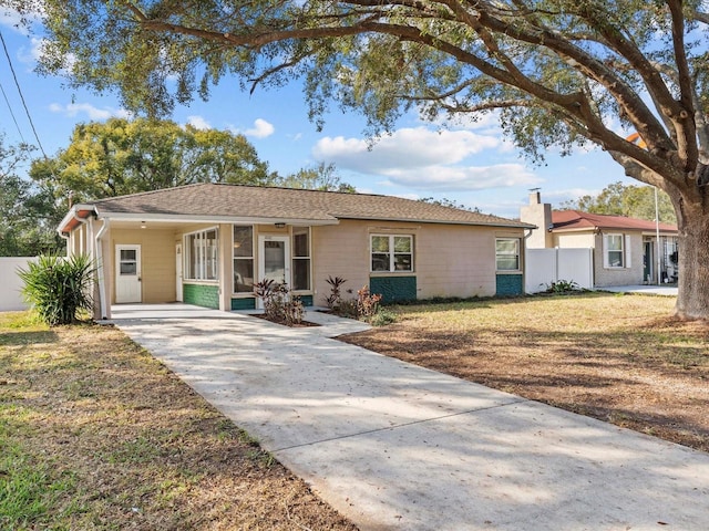 single story home with a carport and a front lawn