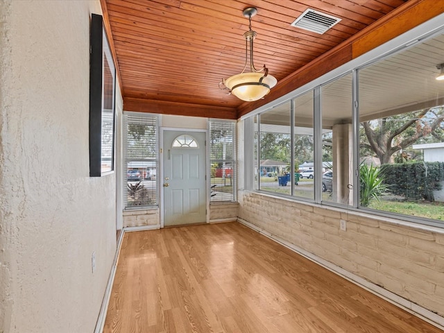 unfurnished sunroom featuring wood ceiling