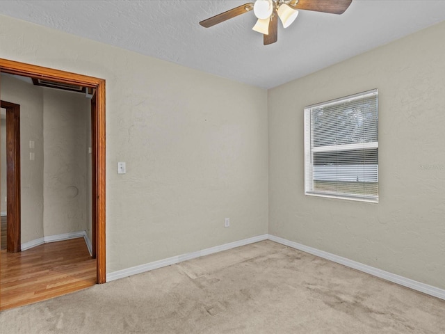 carpeted spare room with ceiling fan