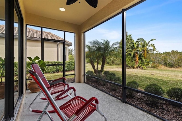 sunroom / solarium featuring ceiling fan