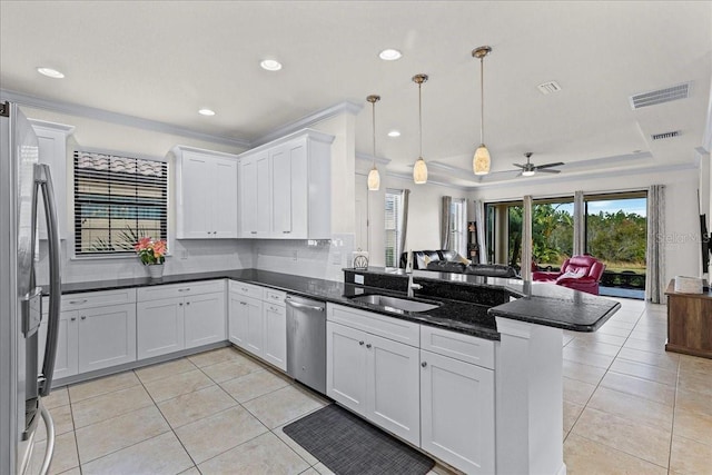 kitchen featuring kitchen peninsula, sink, hanging light fixtures, stainless steel appliances, and white cabinets