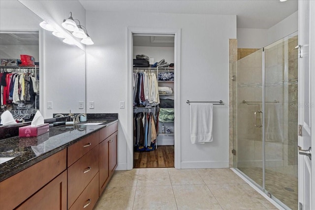 bathroom featuring vanity, tile patterned floors, and a shower with door