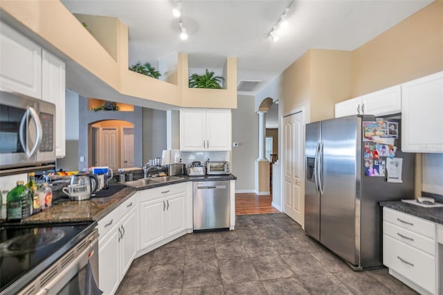 kitchen with sink, stainless steel appliances, and white cabinetry