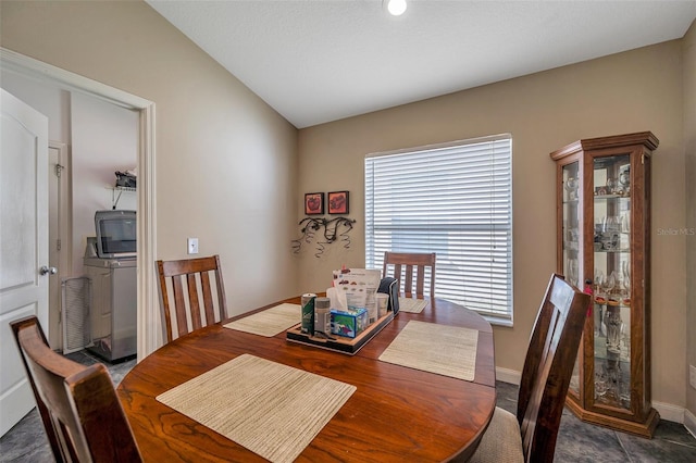 dining space with washing machine and dryer and vaulted ceiling