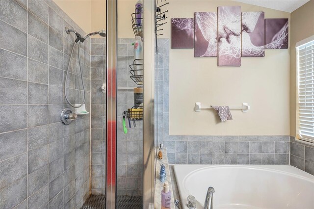 bathroom featuring independent shower and bath