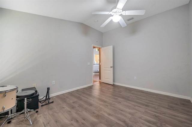 unfurnished office with ceiling fan, hardwood / wood-style floors, and lofted ceiling