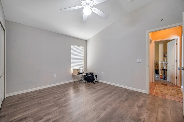 unfurnished bedroom with ceiling fan, wood-type flooring, and vaulted ceiling