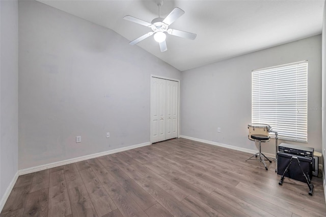 unfurnished bedroom with light hardwood / wood-style floors, a closet, ceiling fan, and vaulted ceiling