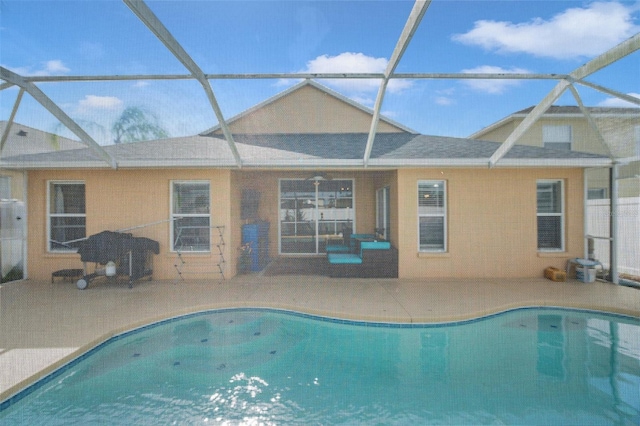 view of swimming pool with a patio area and glass enclosure