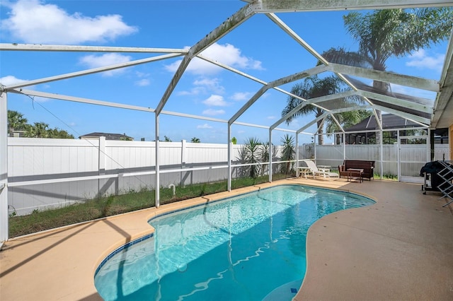 view of swimming pool featuring a patio area and a lanai