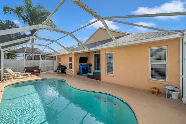 view of swimming pool featuring a lanai and a patio