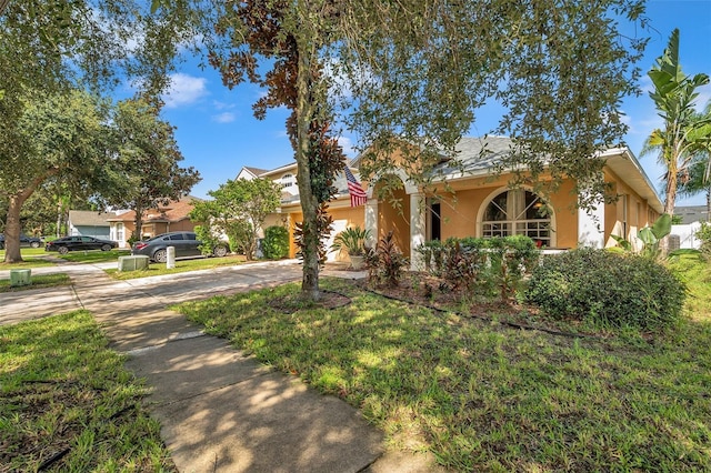 mediterranean / spanish home with a front lawn