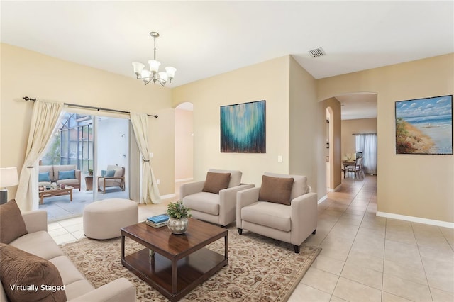 living room featuring light tile patterned flooring and an inviting chandelier