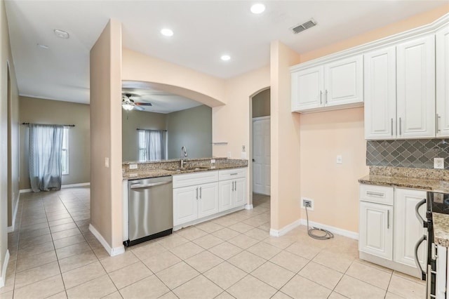 kitchen with ceiling fan, tasteful backsplash, light stone countertops, white cabinets, and stainless steel dishwasher