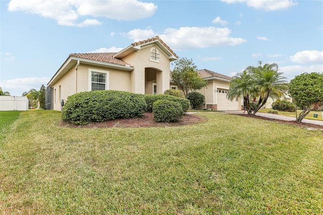 mediterranean / spanish-style home featuring a garage and a front yard