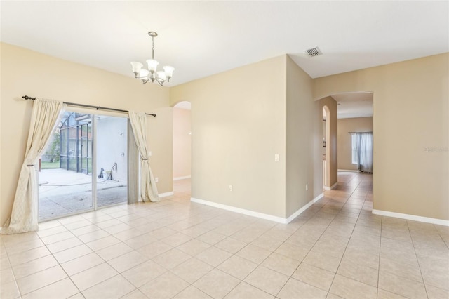 tiled empty room with a chandelier