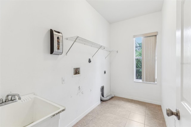 laundry area featuring washer hookup, sink, hookup for an electric dryer, and light tile patterned flooring