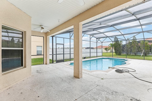 view of swimming pool featuring a lanai and a patio