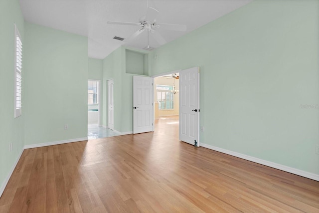 spare room featuring ceiling fan, light hardwood / wood-style flooring, and a wealth of natural light