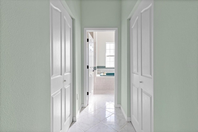 hall featuring light tile patterned floors