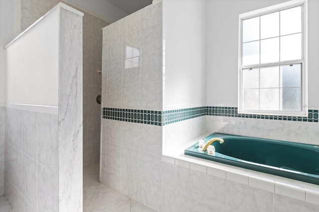 bathroom featuring plus walk in shower and tile patterned floors