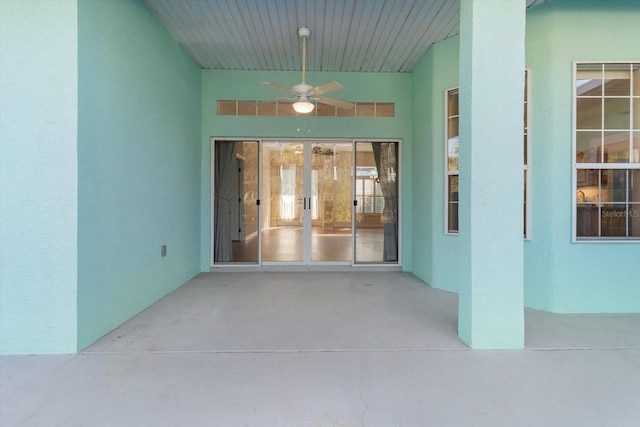 view of exterior entry featuring a patio and ceiling fan