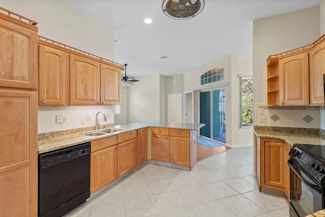 kitchen featuring light stone counters, kitchen peninsula, black appliances, decorative backsplash, and sink