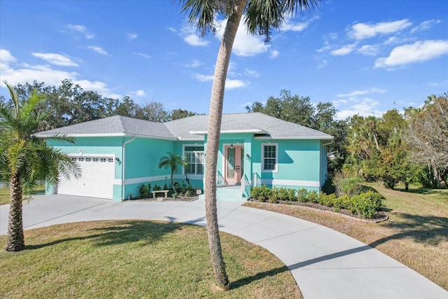 view of front of home featuring a front yard and a garage