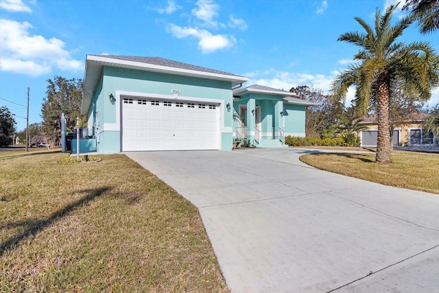 view of front of house with a front yard and a garage