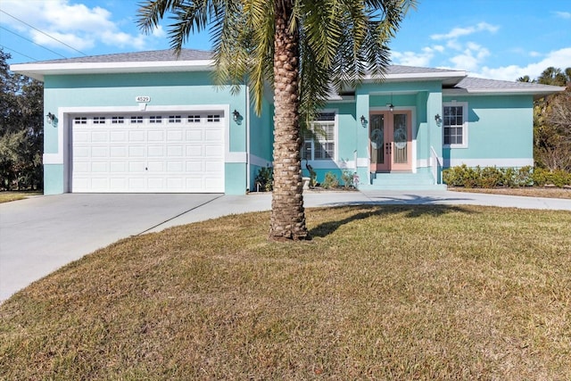 view of front of property with a front yard and a garage