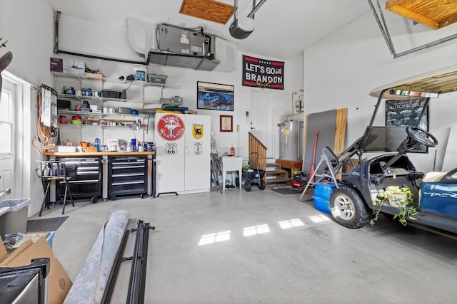 garage featuring a workshop area, water heater, and a garage door opener