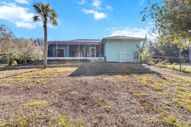 rear view of property with a lawn