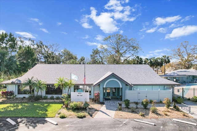 ranch-style home with a front lawn