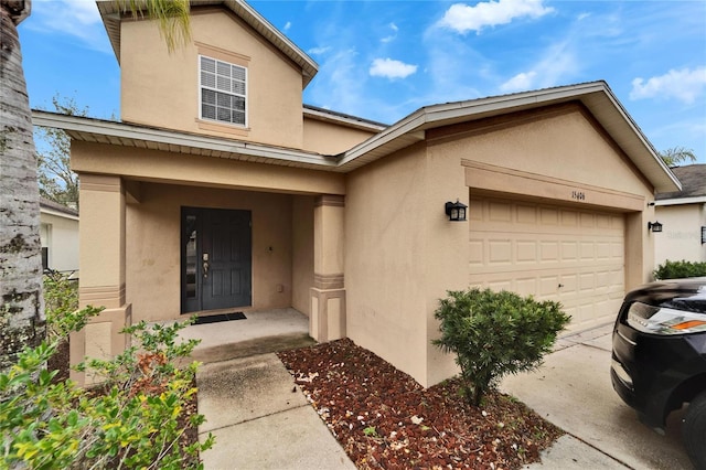 view of exterior entry with a garage