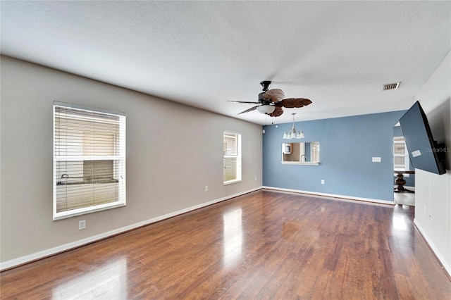 unfurnished living room featuring hardwood / wood-style floors, a textured ceiling, and ceiling fan