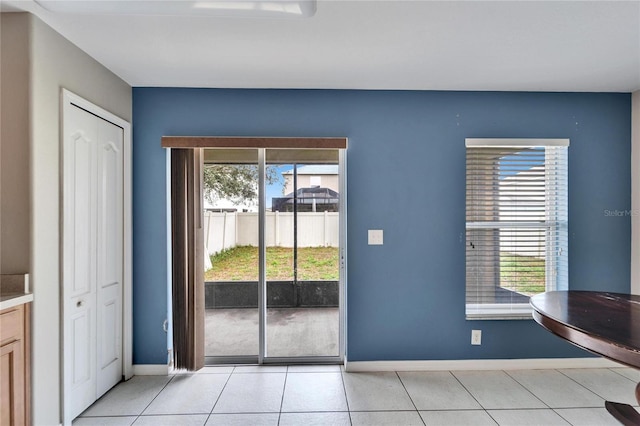 doorway to outside with light tile patterned floors