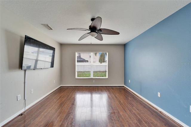 spare room featuring a textured ceiling, dark hardwood / wood-style floors, and ceiling fan