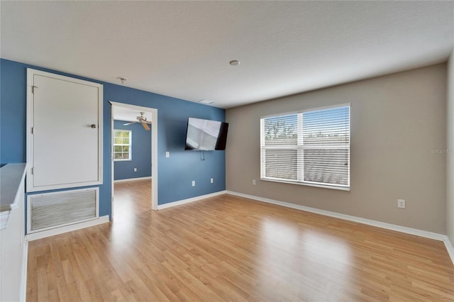 unfurnished room with light wood-type flooring