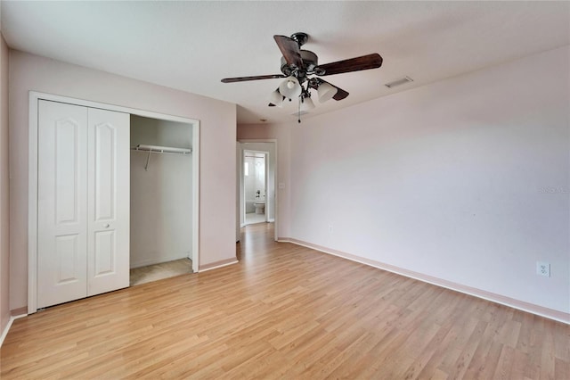 unfurnished bedroom with light wood-type flooring, a closet, and ceiling fan