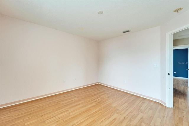 spare room with light hardwood / wood-style floors