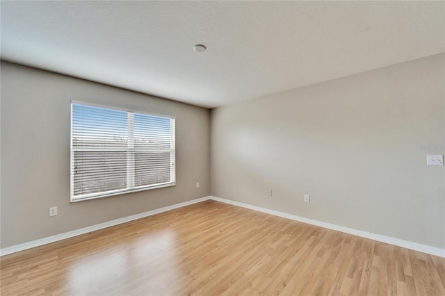 unfurnished room with light hardwood / wood-style floors