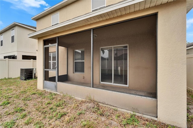 rear view of property featuring a sunroom