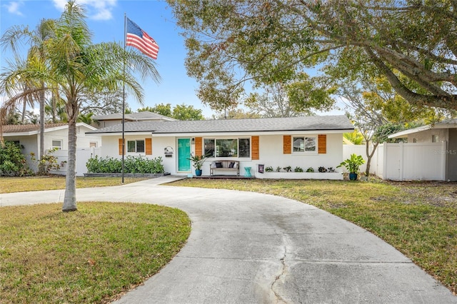 ranch-style home featuring a front yard