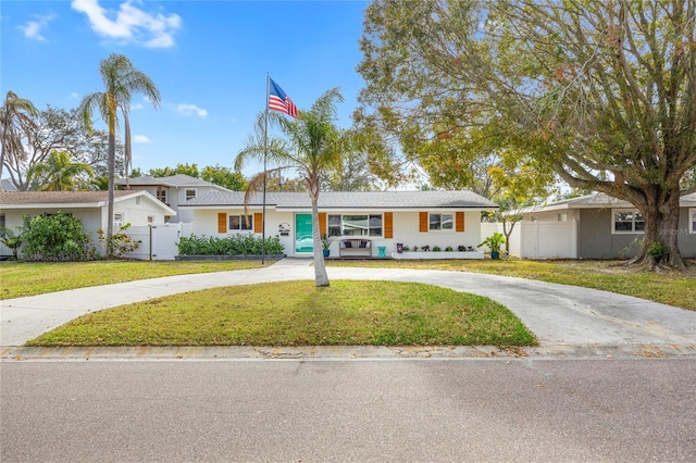 ranch-style home with a front yard